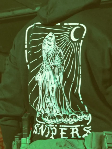the trace shirt featuring a reaper with a sniper standing on skulls