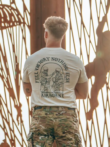 tshirtfeaturing World War II design of two soldiers standing before a parachute jump