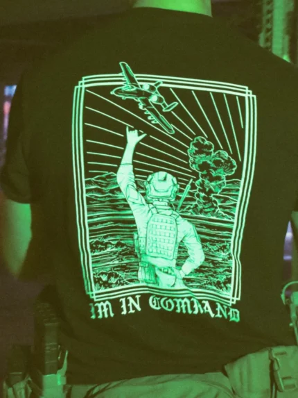 the trace apparel collection featuring a fst jtac guy standing in front of a firing plane