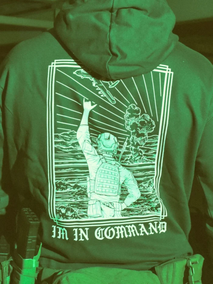 the trace apparel collection featuring a fst jtac guy standing in front of a firing plane