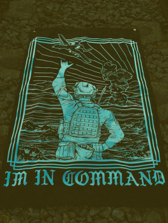 the trace apparel collection featuring a fst jtac guy standing in front of a firing plane