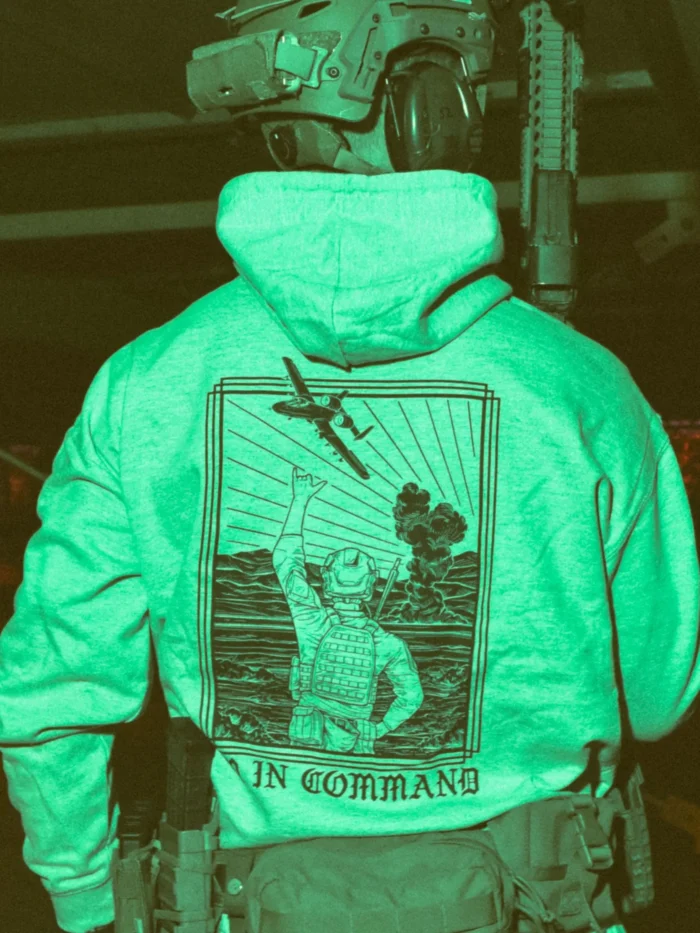 the trace apparel collection featuring a fst jtac guy standing in front of a firing plane