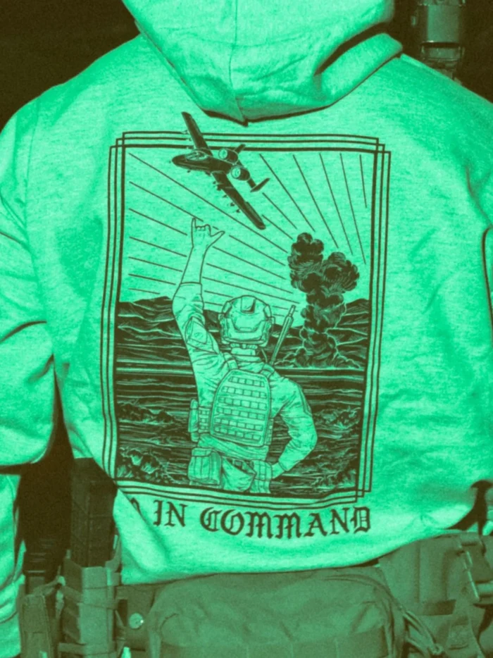 the trace apparel collection featuring a fst jtac guy standing in front of a firing plane