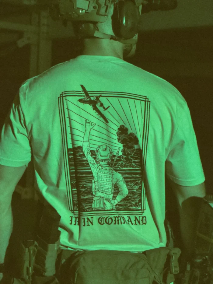 the trace apparel collection featuring a fst jtac guy standing in front of a firing plane