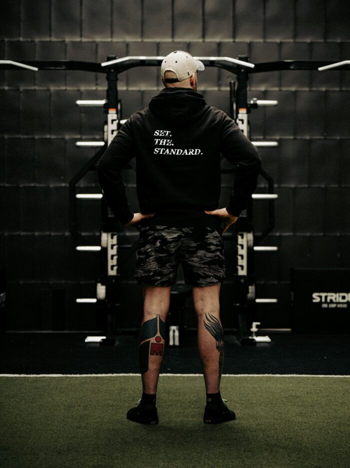 Black hoodie from The Trace featuring Set the Standard design symbolizing the pursuit of the highest performance