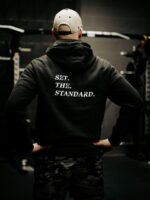 Black hoodie from The Trace featuring Set the Standard design symbolizing the pursuit of the highest performance