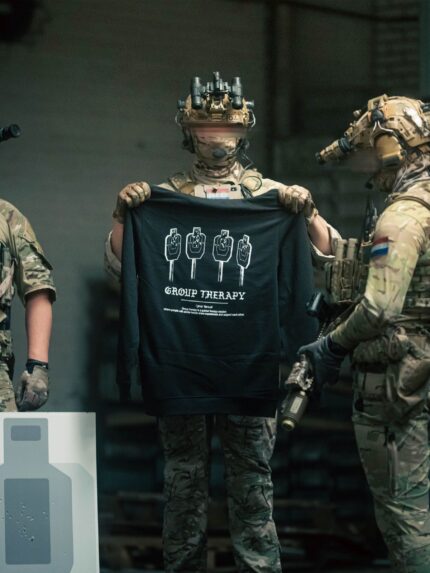 Black hoodie from The Trace featuring Group Therapy design with four targets marked by tight bullet hole groupings