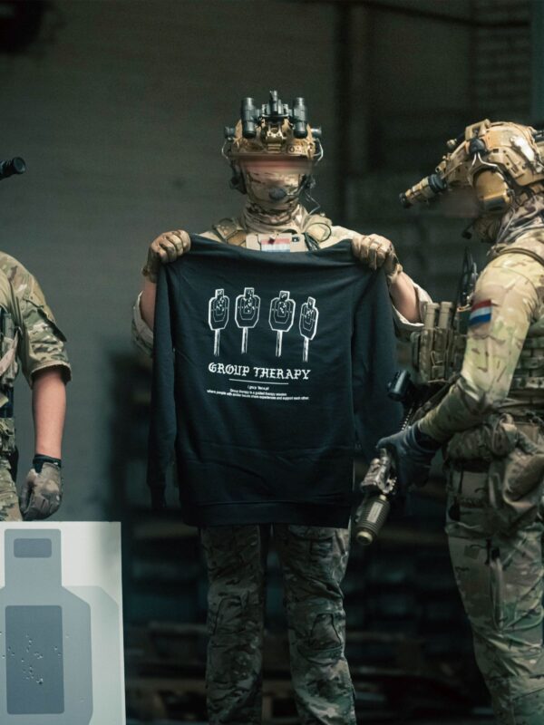 Black hoodie from The Trace featuring Group Therapy design with four targets marked by tight bullet hole groupings