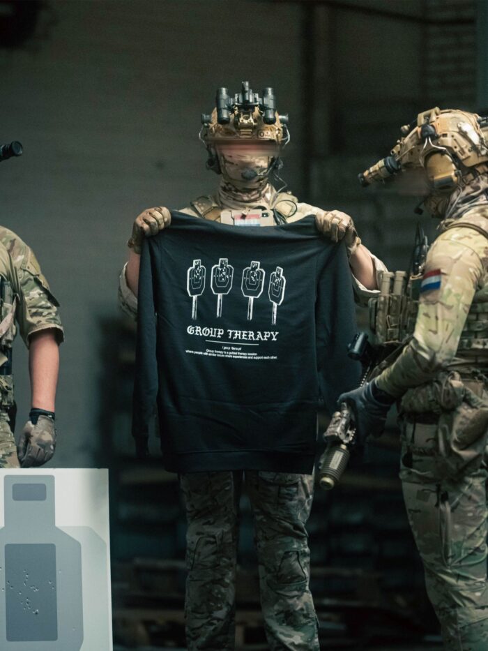 Black hoodie from The Trace featuring Group Therapy design with four targets marked by tight bullet hole groupings