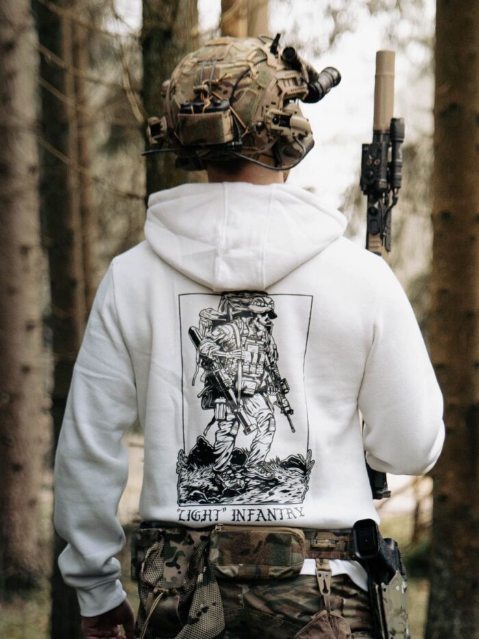 white hoodie from The Trace depicting Light Infantry design with a soldier standing with a heavy backpack