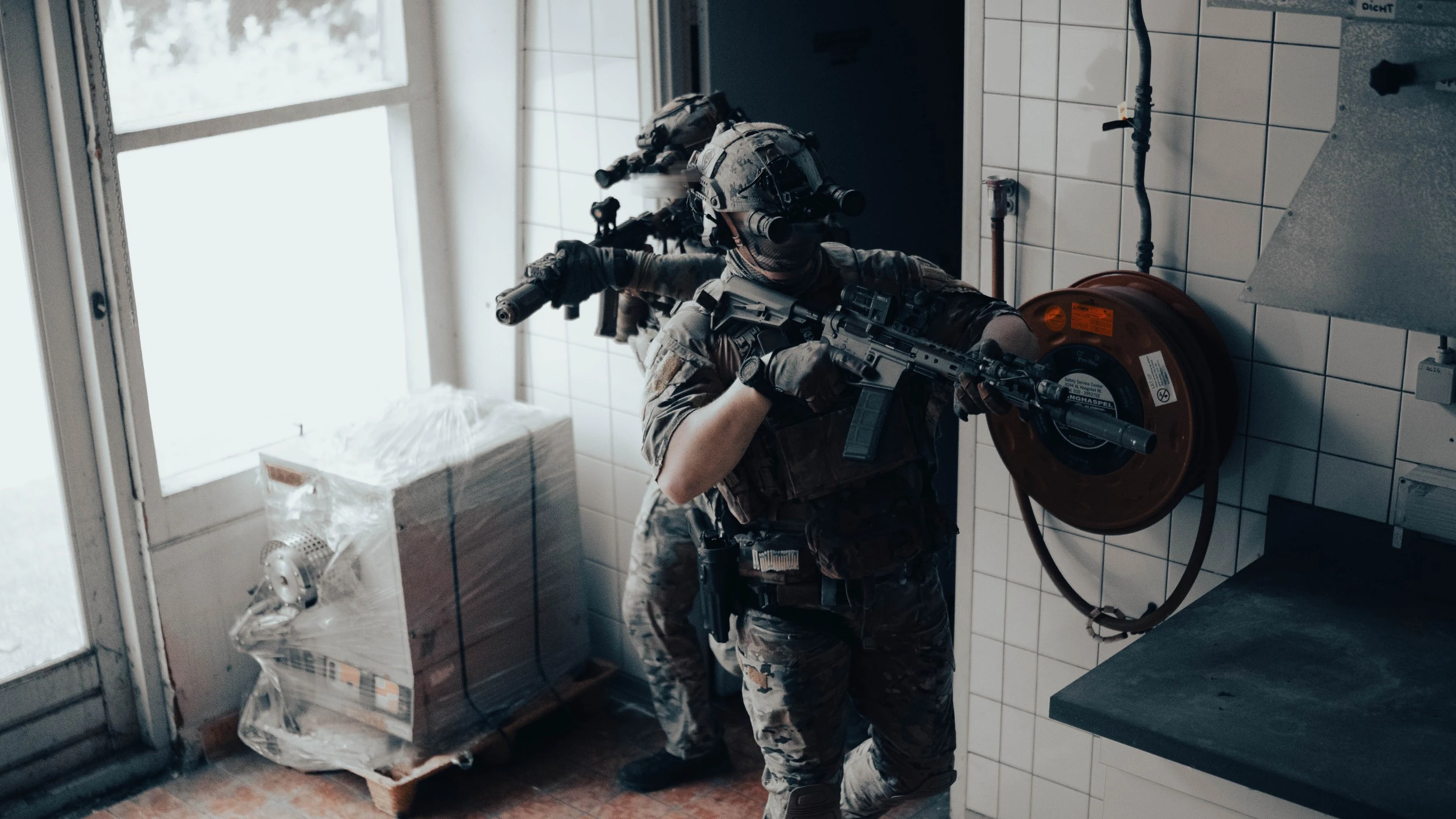 The Trace featuring dynamic photo of operators conducting close quarters battle