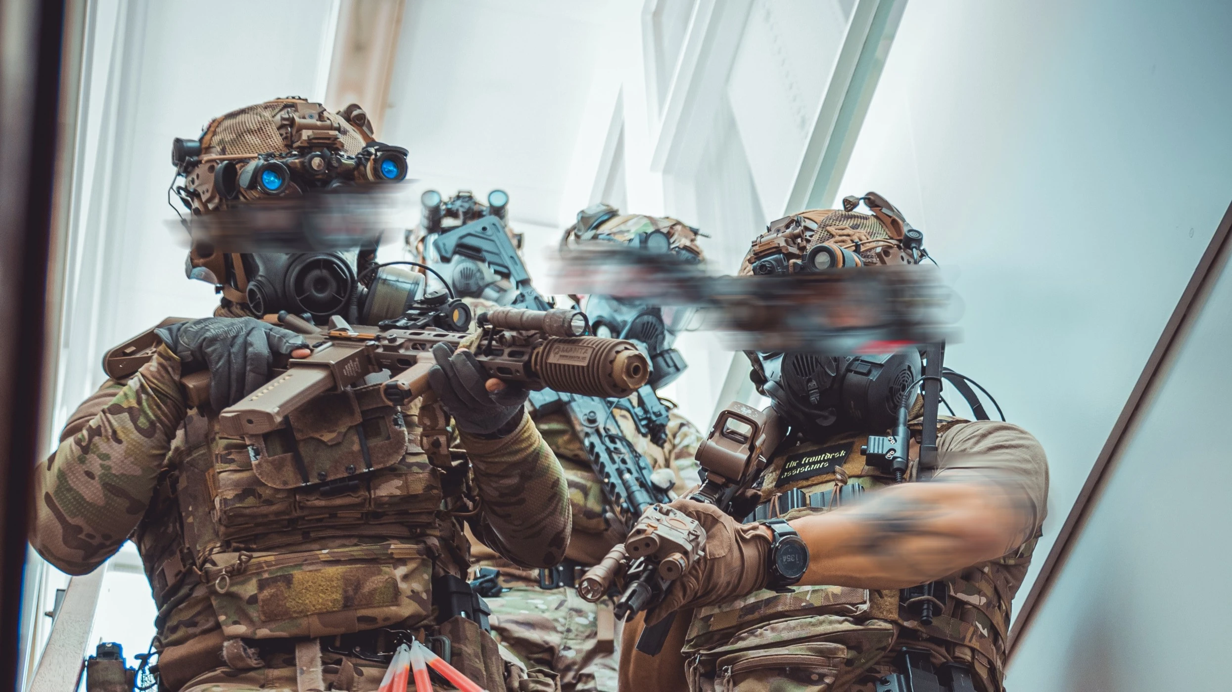 The Trace featuring dynamic photo of operators conducting close quarters battle