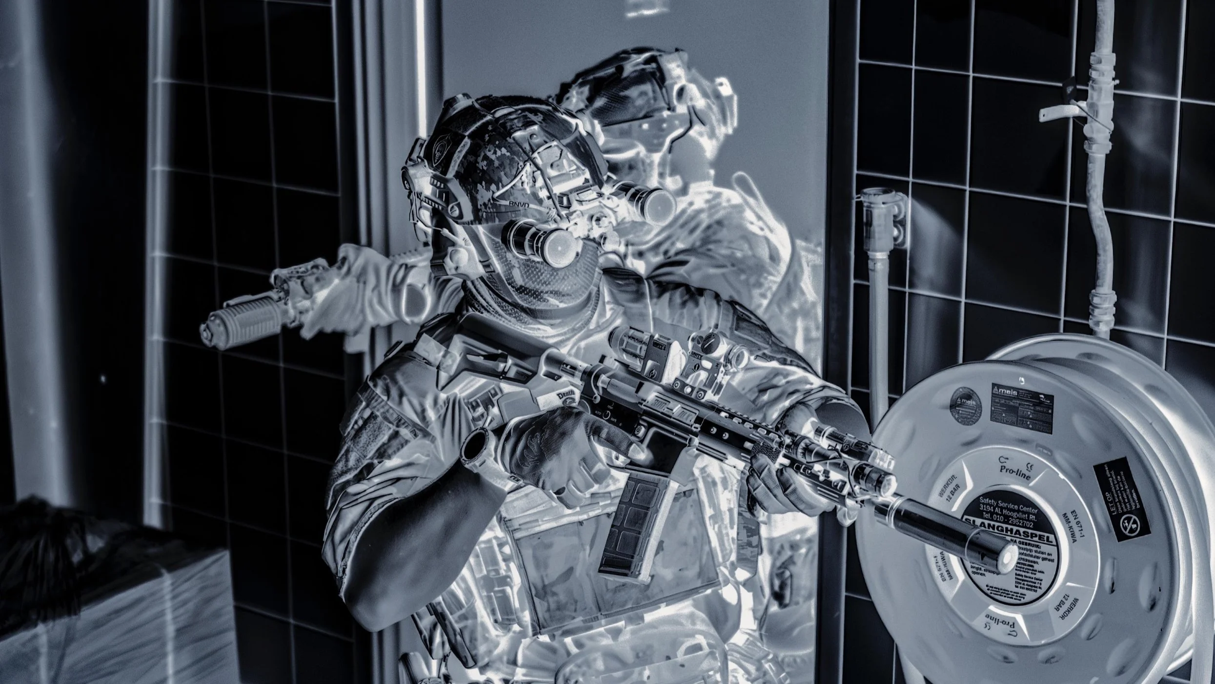 The Trace featuring dynamic photo of operators conducting close quarters battle