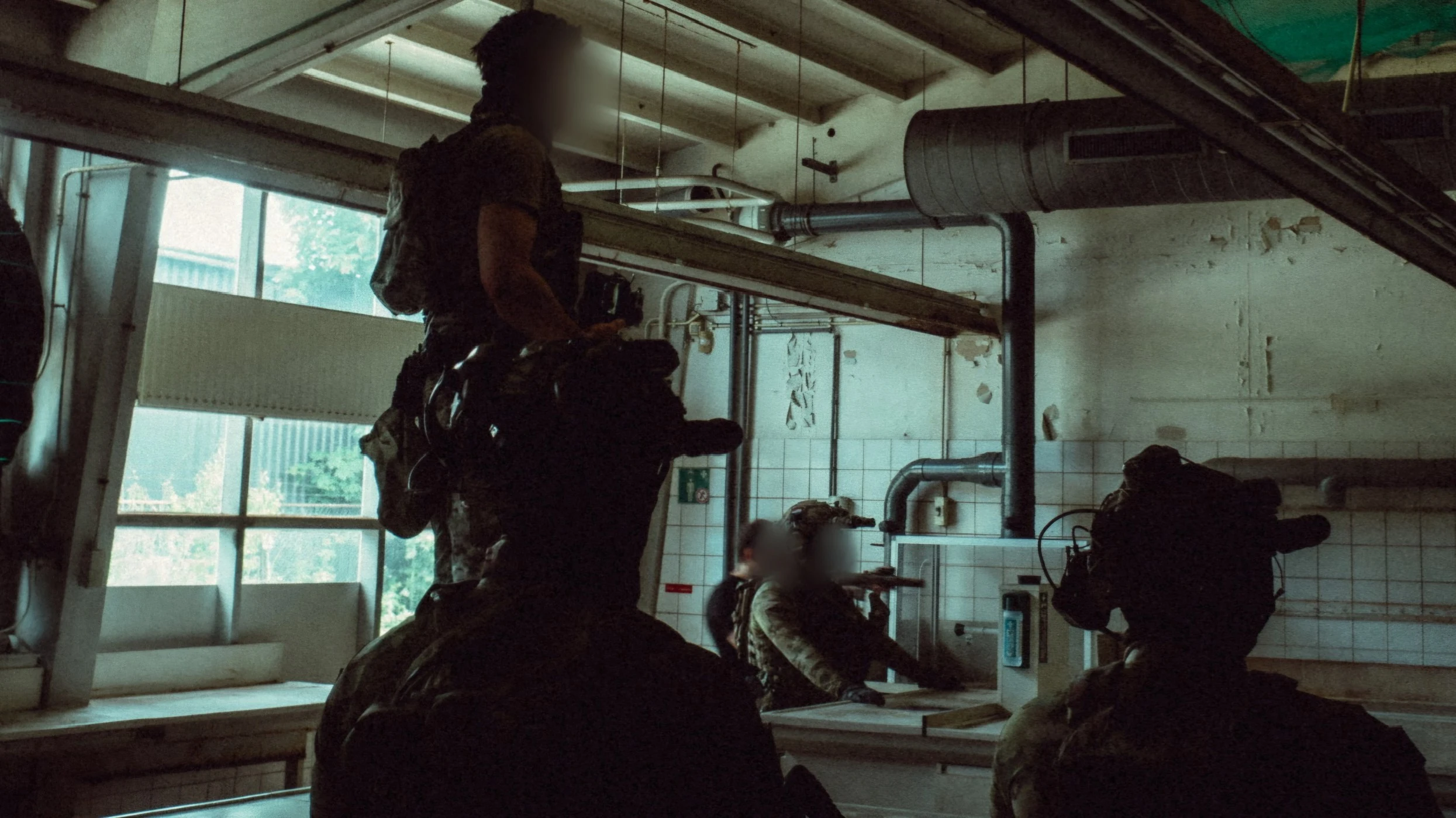 The Trace featuring dynamic photo of operators conducting close quarters battle