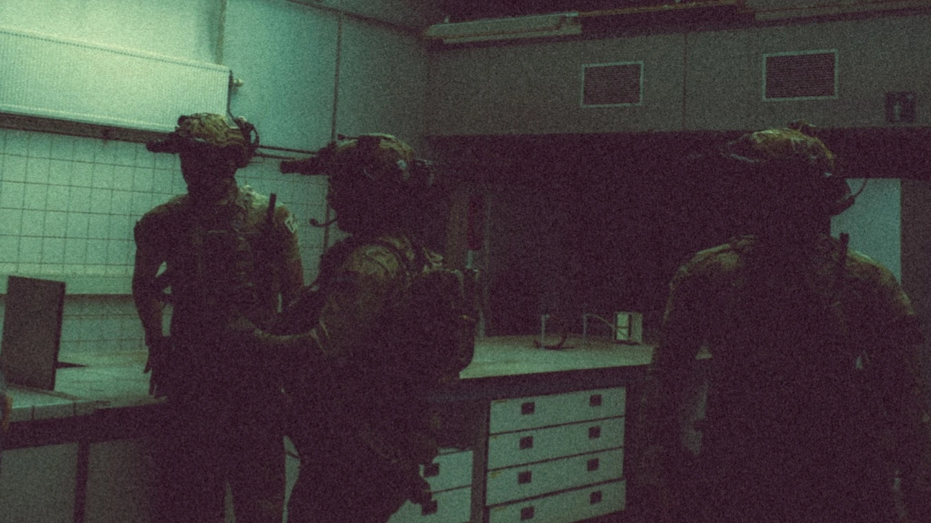 The Trace featuring dynamic photo of operators conducting close quarters battle