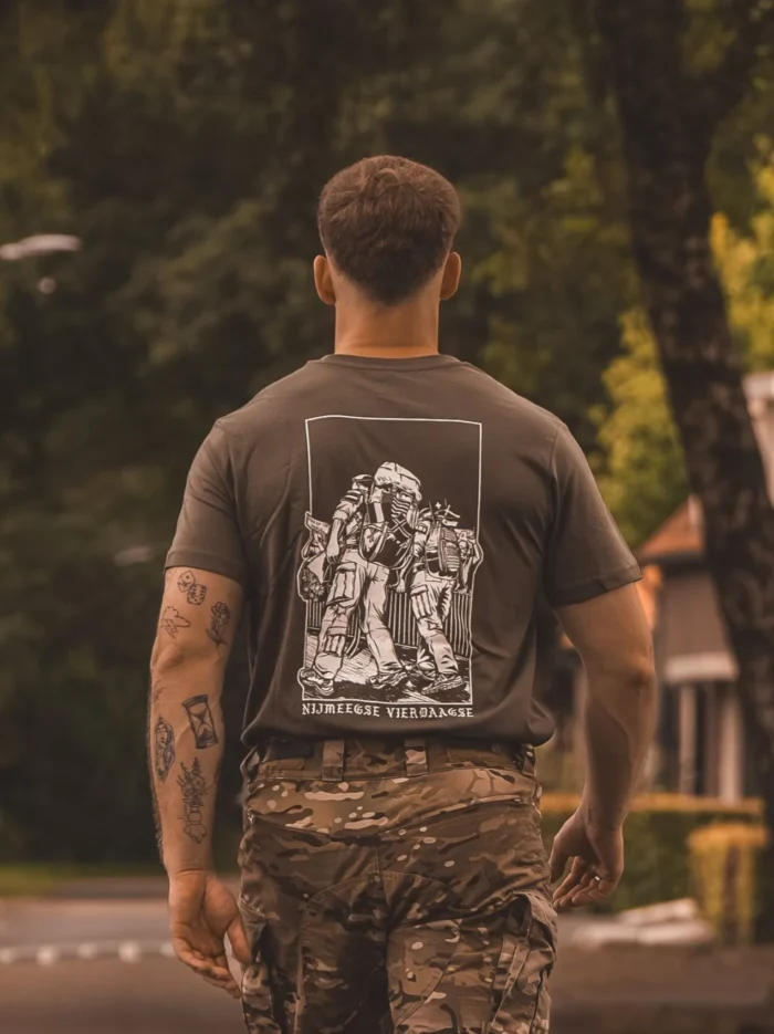olive T-shirt from The Trace featuring design of two soldiers marching in the Nijmegen Four Days Marches