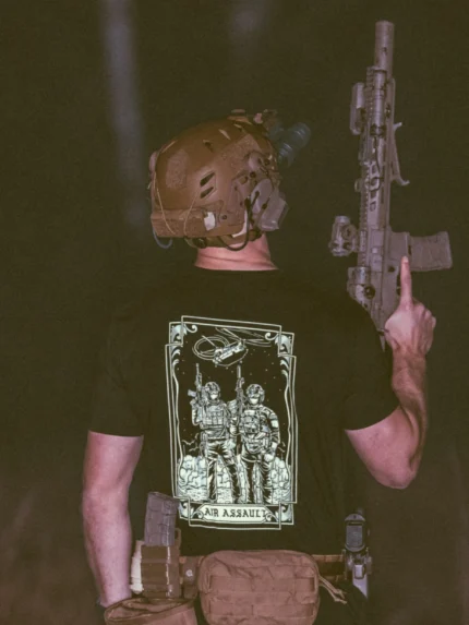the trace apparel collection featuring 2 air assault operators standing in front of a chinook