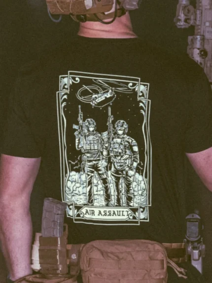 the trace apparel collection featuring 2 air assault operators standing in front of a chinook