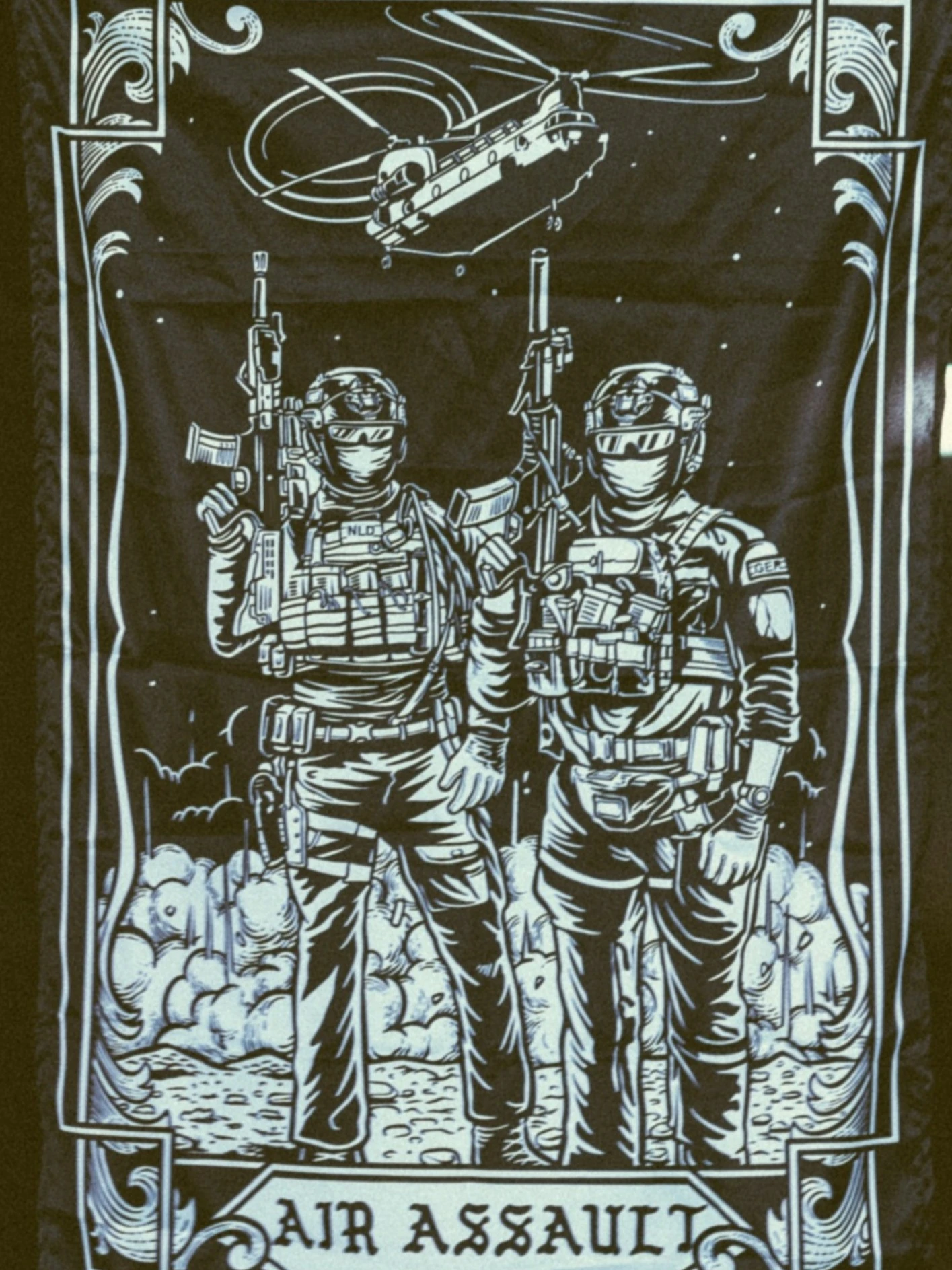 the trace apparel collection featuring 2 air assault operators standing in front of a chinook