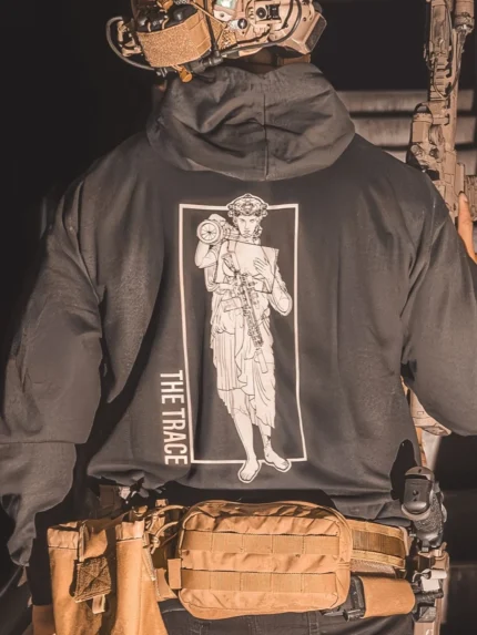 black hoodie featuring a girl carrying an anti tank weapon.
