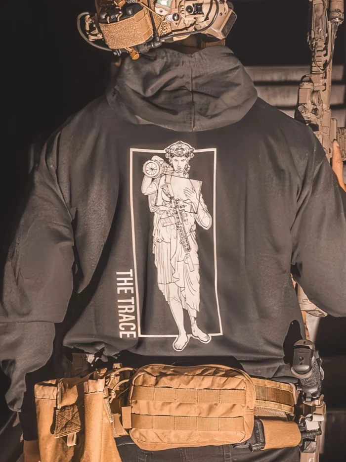 black hoodie featuring a girl carrying an anti tank weapon.