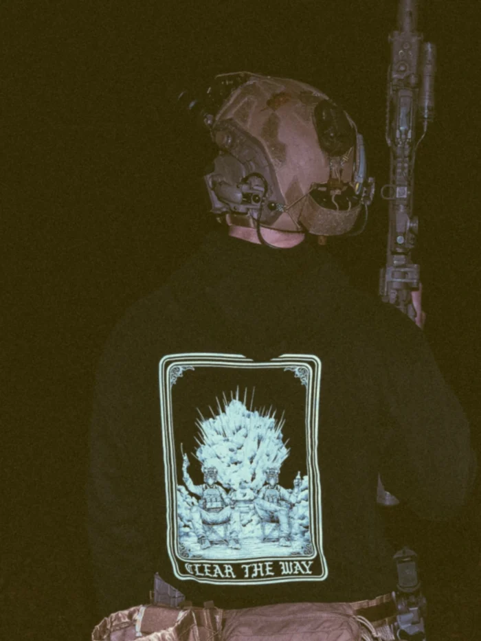 the trace apparel collection with 2 guys sitting in front of a explosing because they are part of the eod