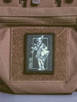 the trace apparel collection patch featuring a woman holding a machine gun