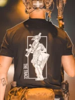 black shirt from The Trace featuring a girl carrying a machinegun