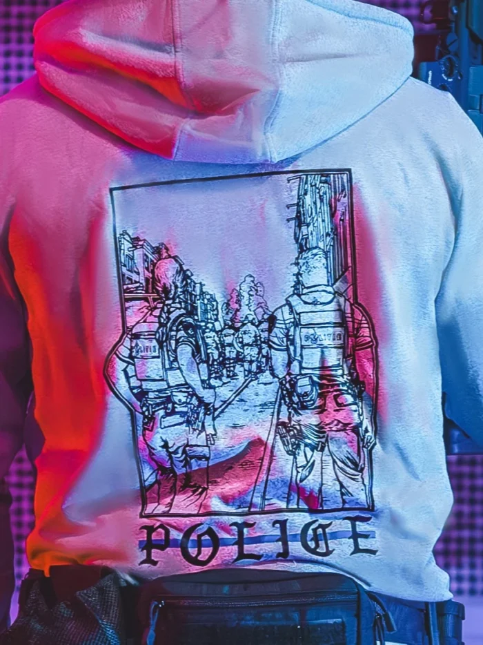 the trace apparel collection featuring two police cops standing in a street watching a riot