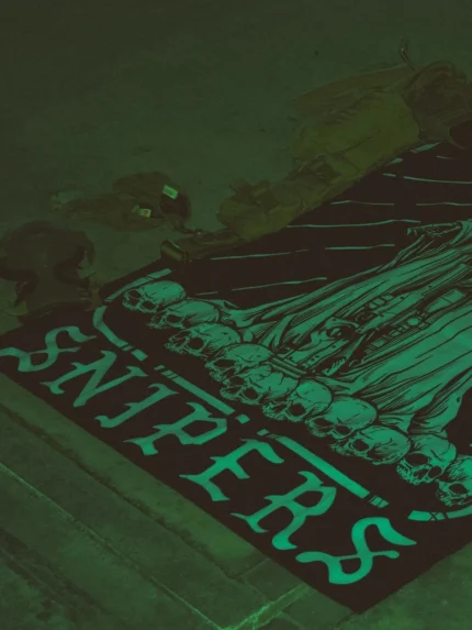 Combat flag displaying a sniper skeleton atop skulls, gripping an Arctic Warfare Super Magnum in a bold, battlefield stance.