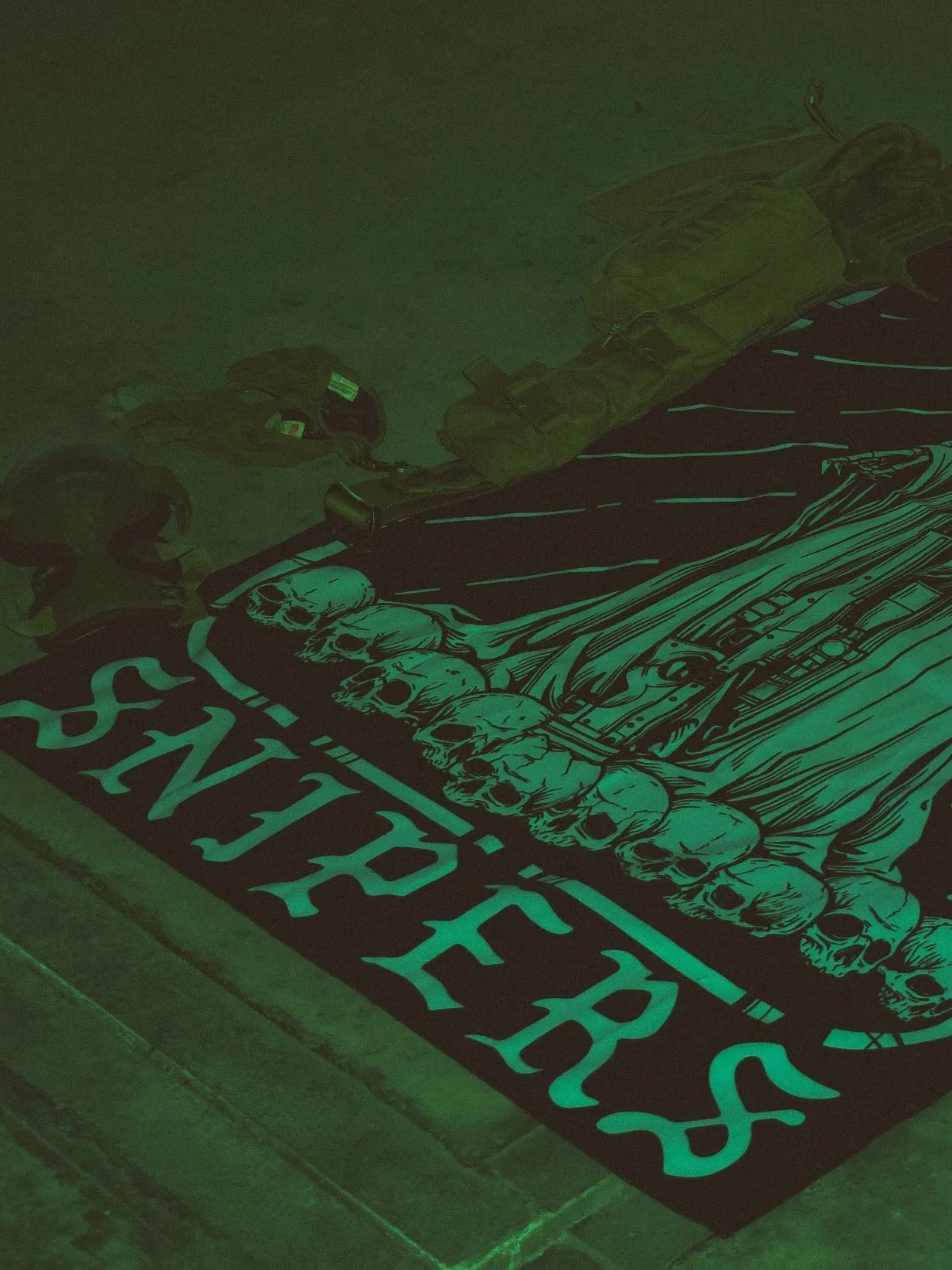 Combat flag displaying a sniper skeleton atop skulls, gripping an Arctic Warfare Super Magnum in a bold, battlefield stance.