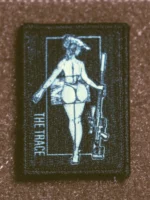 the trace apparel collection patch featuring a woman holding a sniper