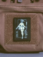 the trace apparel collection patch featuring a woman holding a sniper