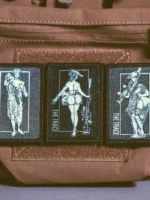 the trace apparel collection patch featuring 3 woman holding a sniper machine gun and anti tank weapon