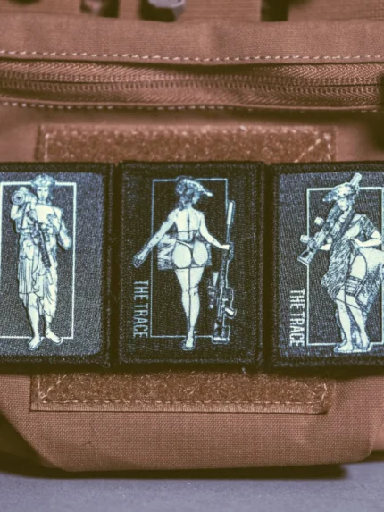 the trace apparel collection patch featuring 3 woman holding a sniper machine gun and anti tank weapon