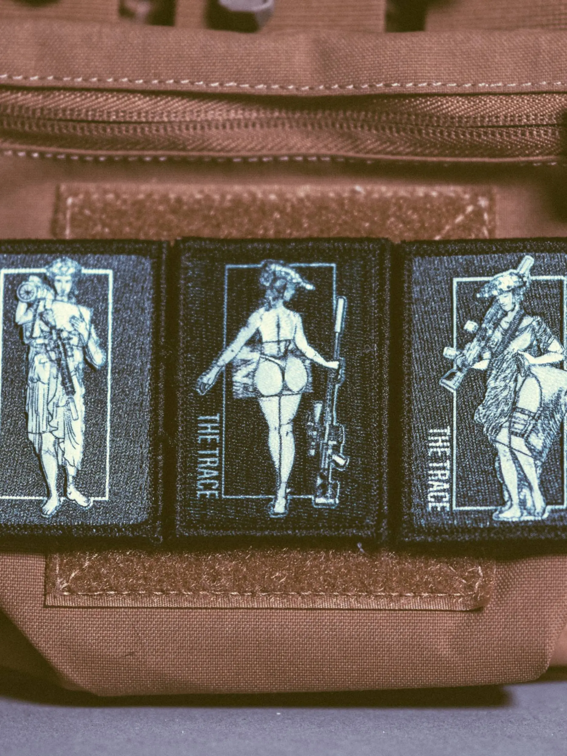 the trace apparel collection patch featuring 3 woman holding a sniper machine gun and anti tank weapon