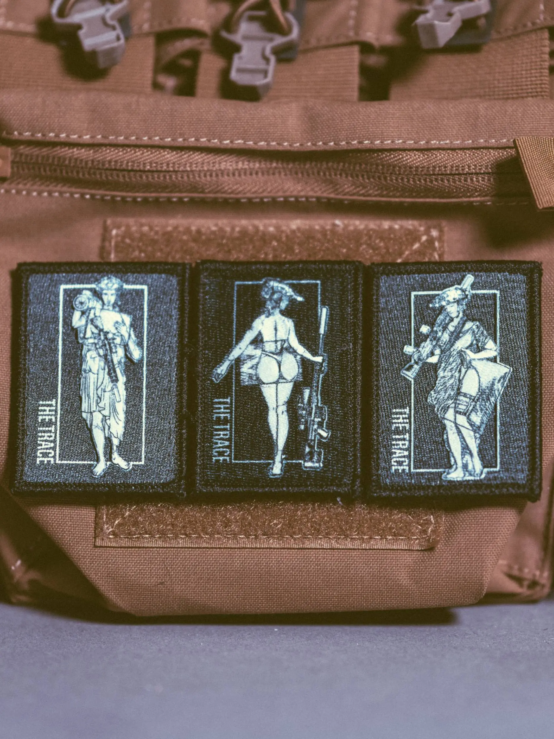the trace apparel collection patch featuring 3 woman holding a sniper machine gun and anti tank weapon
