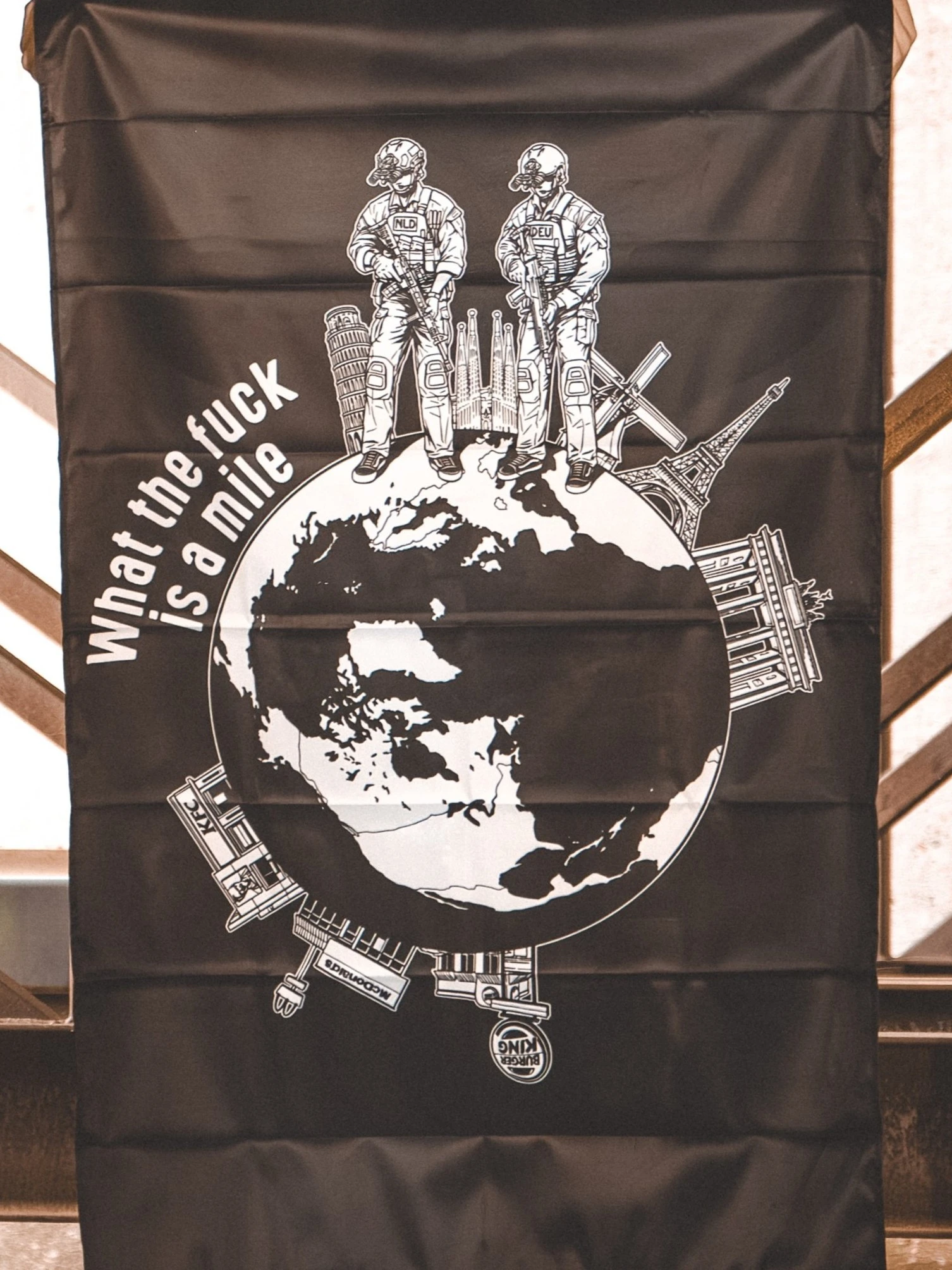 the trace apparel collection featuring 2 operators standing on europe and watching america saying wtf is a mile