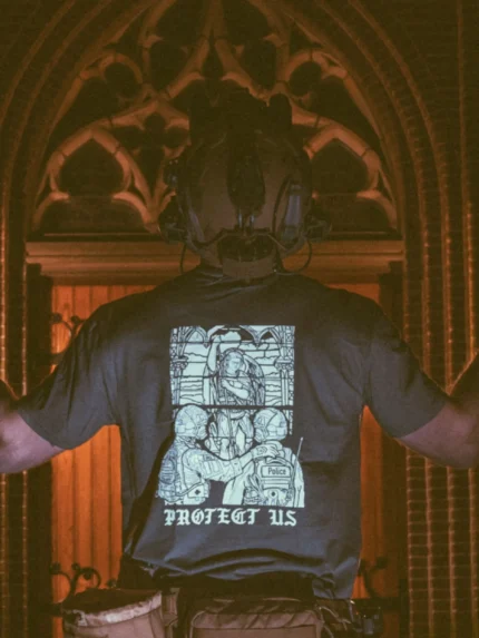 the trace apparel collection featuring a military and a police guy standing in front of a tinted window that displays saint michael the protector