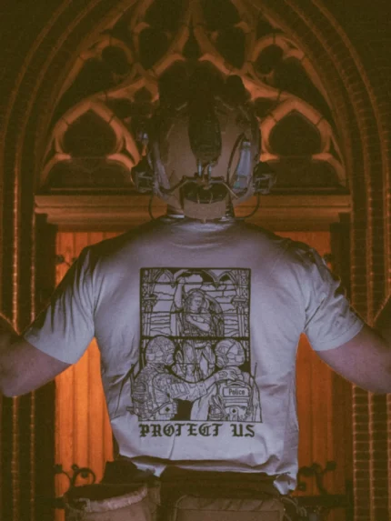 the trace apparel collection featuring a military and a police guy standing in front of a tinted window that displays saint michael the protector