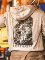 the trace hoodie featuring a firefighter standing in front of a firetruck
