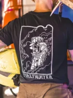 the trace shirt featuring a firefighter standing in front of a firetruck